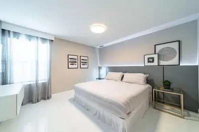 a white bedroom with a bed and a window at Storey Lake Resort 9Q c/ Piscina & Game Room in Kissimmee