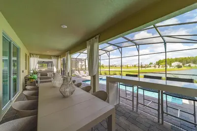 a dining room with a table and a view of the water at Storey Lake Resort 9Q c/ Piscina & Game Room in Kissimmee