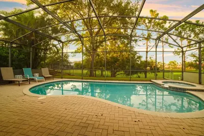 a swimming pool in a building with a glass roof at 4BR Family Villa Pool Game Room Near Disney in Orlando