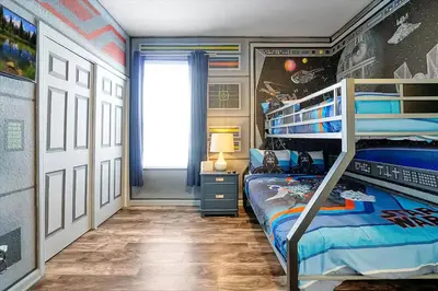 a bedroom with two bunk beds and a window at 4BR Family Villa Pool Game Room Near Disney in Orlando