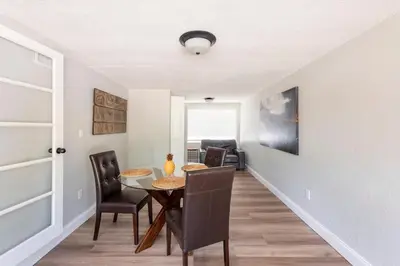 a dining room with a table and chairs at The Pineapple Express in Orlando