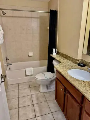 a bathroom with a tub and a toilet and a sink at Entire Condo 3Bed 2Bath 5 mins to Disney Park in Orlando