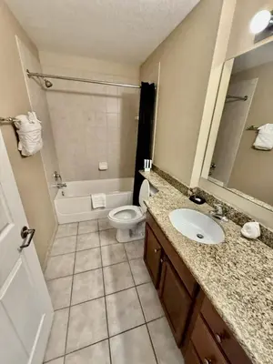a bathroom with a sink and a toilet and a tub at Entire Condo 3Bed 2Bath 5 mins to Disney Park in Orlando