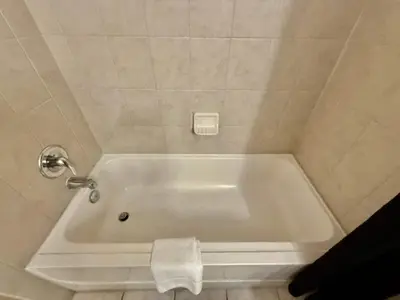 a bath tub in a bathroom with a towel at Entire Condo 3Bed 2Bath 5 mins to Disney Park in Orlando