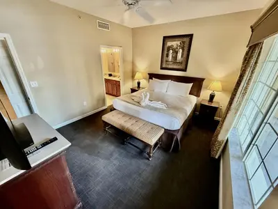a bedroom with a bed and a desk and a television at Entire Condo 3Bed 2Bath 5 mins to Disney Park in Orlando