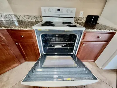 an oven with its door open in a kitchen at Entire Condo 3Bed 2Bath 5 mins to Disney Park in Orlando