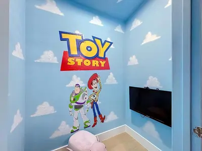 a room with a toy story mural on the wall at The Roundup Retreat! in Orlando