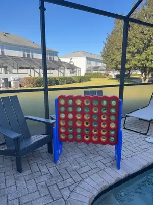 a giant lego game on a swing next to a pool at The Roundup Retreat! in Orlando