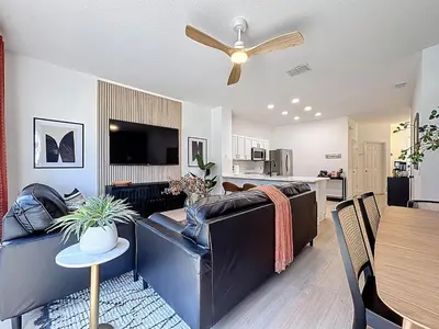 a living room with a couch and a ceiling fan at The Roundup Retreat! in Orlando