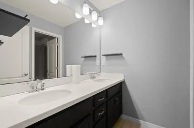 a bathroom with two sinks and a large mirror at Comfort & Charm in Central Florida in Sanford