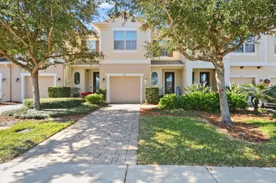 a house with trees in front of a driveway at Comfort & Charm in Central Florida in Sanford