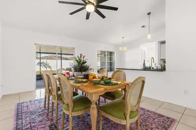 a dining room with a wooden table and chairs at Residentas Hali Ridge in Orlando