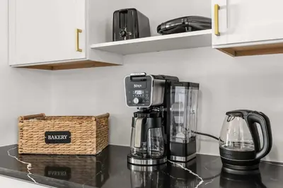a coffee maker on a counter in a kitchen at Residentas Hali Ridge in Orlando