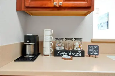 a kitchen counter with a coffee pot on a counter top at Universal Studios EPIC Splash Park 2BR CONDO ADA in Orlando
