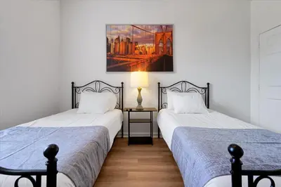 two beds sitting next to each other in a bedroom at Universal Studios EPIC Splash Park 2BR CONDO ADA in Orlando