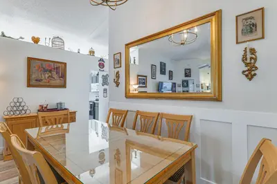 a dining room with a glass table and a mirror at Visit Disney and Universal Parks! Group-Friendly Gem in Orlando