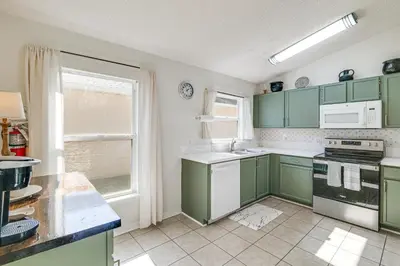 a kitchen with green cabinets and a window at Visit Disney and Universal Parks! Group-Friendly Gem in Orlando