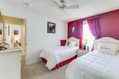 two beds in a room with purple and white at Visit Disney and Universal Parks! Group-Friendly Gem in Orlando