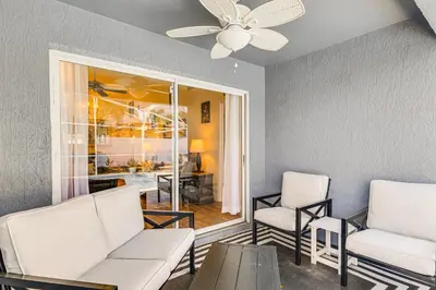 a living room with two chairs and a ceiling fan at Visit Disney and Universal Parks! Group-Friendly Gem in Orlando