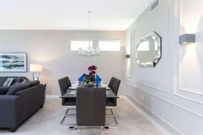 a dining room with a table and a couch at Lake view Near Disney Resort w Lazy River 108 in Kissimmee