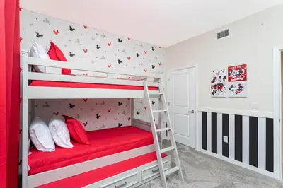 a bedroom with bunk beds with red and white walls at Lake view Near Disney Resort w Lazy River 108 in Kissimmee