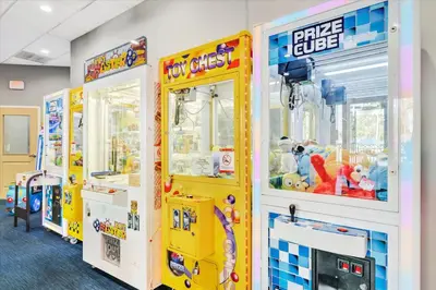 a room with three arcade games and toys at Free Breakfast & Parking 2B Disney Resort Condo in Orlando