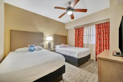 a hotel room with two beds and a ceiling fan at Free Breakfast & Parking 2B Disney Resort Condo in Orlando