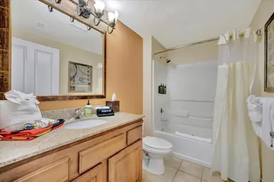 a bathroom with a sink and a toilet and a shower at Free Breakfast & Parking 2B Disney Resort Condo in Orlando