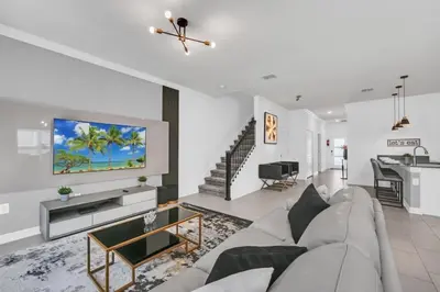 a living room with a couch and a tv at Luxury, Luxury, Luxury Pool Home! townhouse in Kissimmee