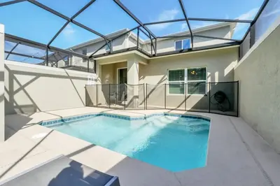 a swimming pool in the backyard of a house at Luxury, Luxury, Luxury Pool Home! townhouse in Kissimmee
