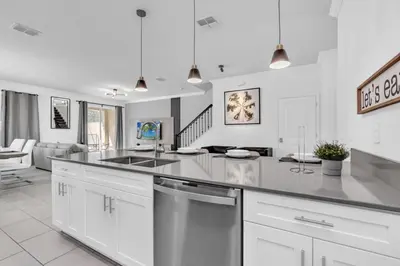 a kitchen with a sink and a counter top at Luxury, Luxury, Luxury Pool Home! townhouse in Kissimmee