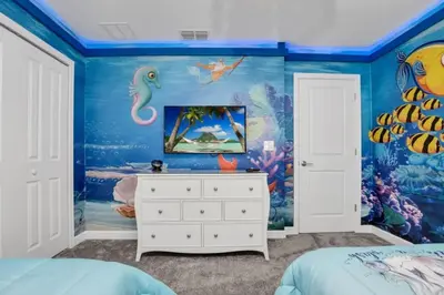 a bedroom with a mermaid themed wall at 9 Bedroom With Everything For Happiness! home in Kissimmee
