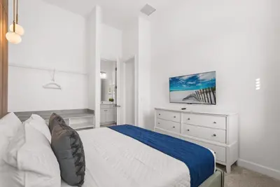 a white bedroom with a bed and a dresser at Kids Will Love! New Premium Theater & Theme Rooms villa in Orlando