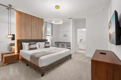 a bedroom with a large bed and a table at Kids Will Love! New Premium Theater & Theme Rooms villa in Orlando