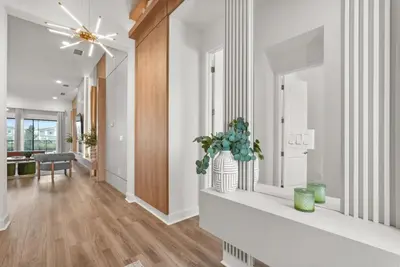 a living room with a ceiling fan and a vase with a plant at Kids Will Love! New Premium Theater & Theme Rooms villa in Orlando