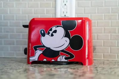a red briefcase with a mickey mouse logo on it at Relaxing Resort Townhome Close to Disney in Kissimmee
