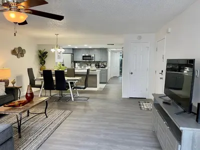 a living room with a table and a dining room at Superior 3BR Condo Apartment Near Disney Attractions in Kissimmee