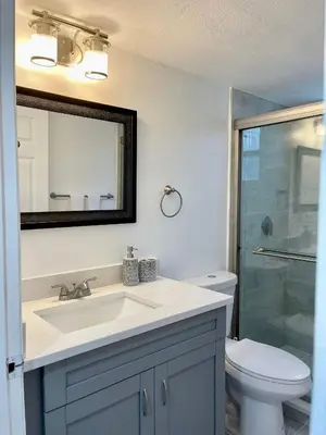 a bathroom with a sink and a toilet and a mirror at Superior 3BR Condo Apartment Near Disney Attractions in Kissimmee