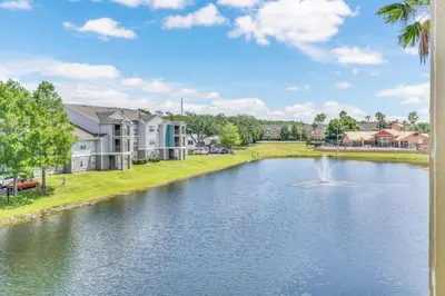 a view of a pond with a fountain at Grand Luxury 2BR Penthouse near Disney Parks in Kissimmee