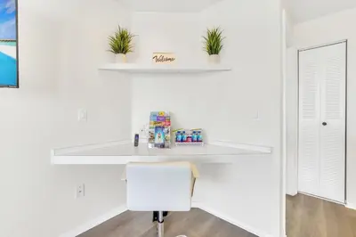 a white desk in a white room with a white chair at Grand Luxury 2BR Penthouse near Disney Parks in Kissimmee