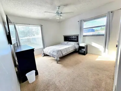 a bedroom with a bed and a ceiling fan at 4 Bedroom Private Pool House - 5 Mi to Convention Center & 7 Mi to Disney in Orlando
