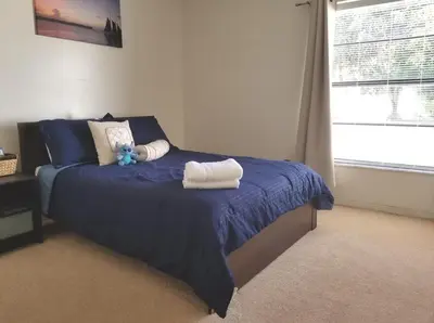a bedroom with a bed with two towels on it at 4 Bedroom Private Pool House - 5 Mi to Convention Center & 7 Mi to Disney in Orlando