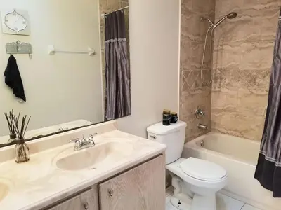 a bathroom with a sink and a toilet and a tub at 4 Bedroom Private Pool House - 5 Mi to Convention Center & 7 Mi to Disney in Orlando