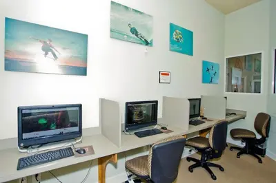 an office with four computer monitors and chairs at Casa 6Q Bella Vida Resort – Perto Disney in Kissimmee
