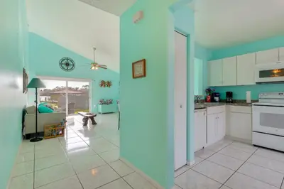 a kitchen with blue walls and white cabinets at Bright Lakefront Sanford Home with Community Pool in Sanford