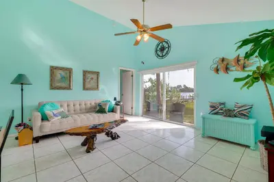 a living room with a couch and a ceiling fan at Bright Lakefront Sanford Home with Community Pool in Sanford
