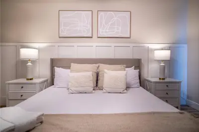 a bedroom with a large white bed with two lamps at Family 3BR Home in Lucaya Resort in Kissimmee