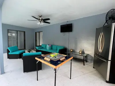 a living room with a couch and a table at Beautiful pool home 15 minutes from Disney! in Kissimmee