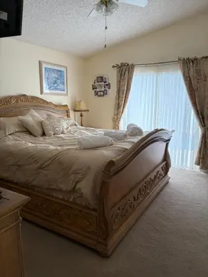 a bedroom with a large bed and a window at 4813 Pliny Court in Kissimmee