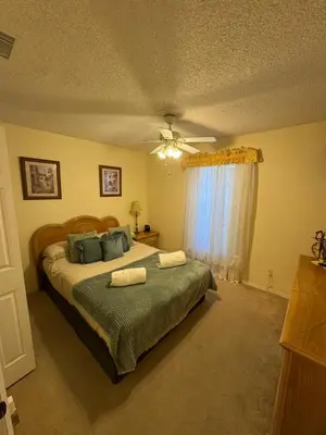 a bedroom with a bed with two towels on it at 4813 Pliny Court in Kissimmee